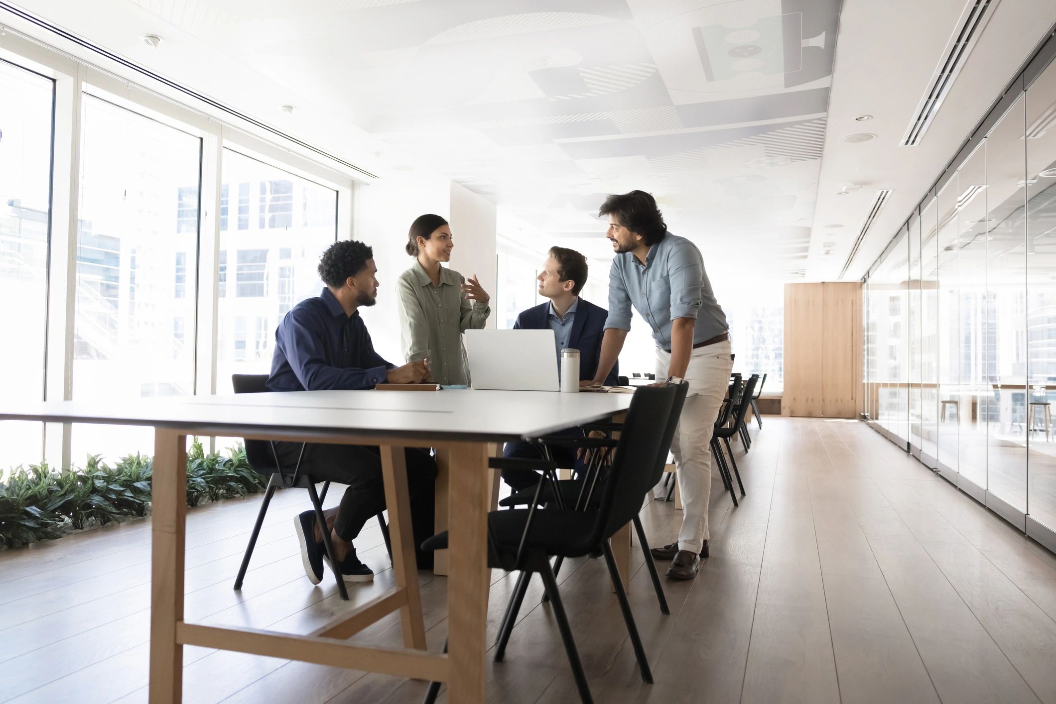 Editorial research team in discussion around a meeting table