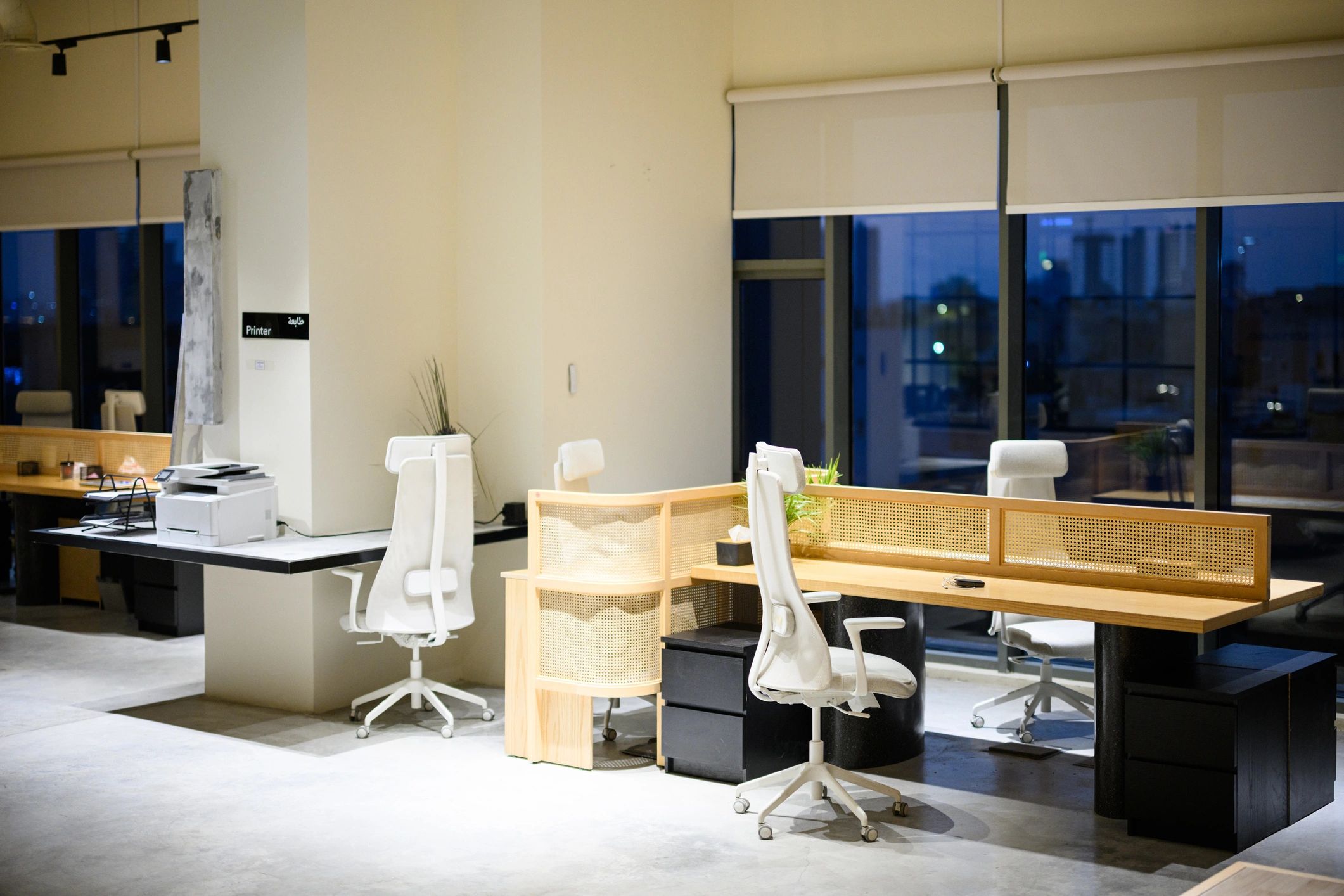 Contemporary editorial workspace with desks and city view at night